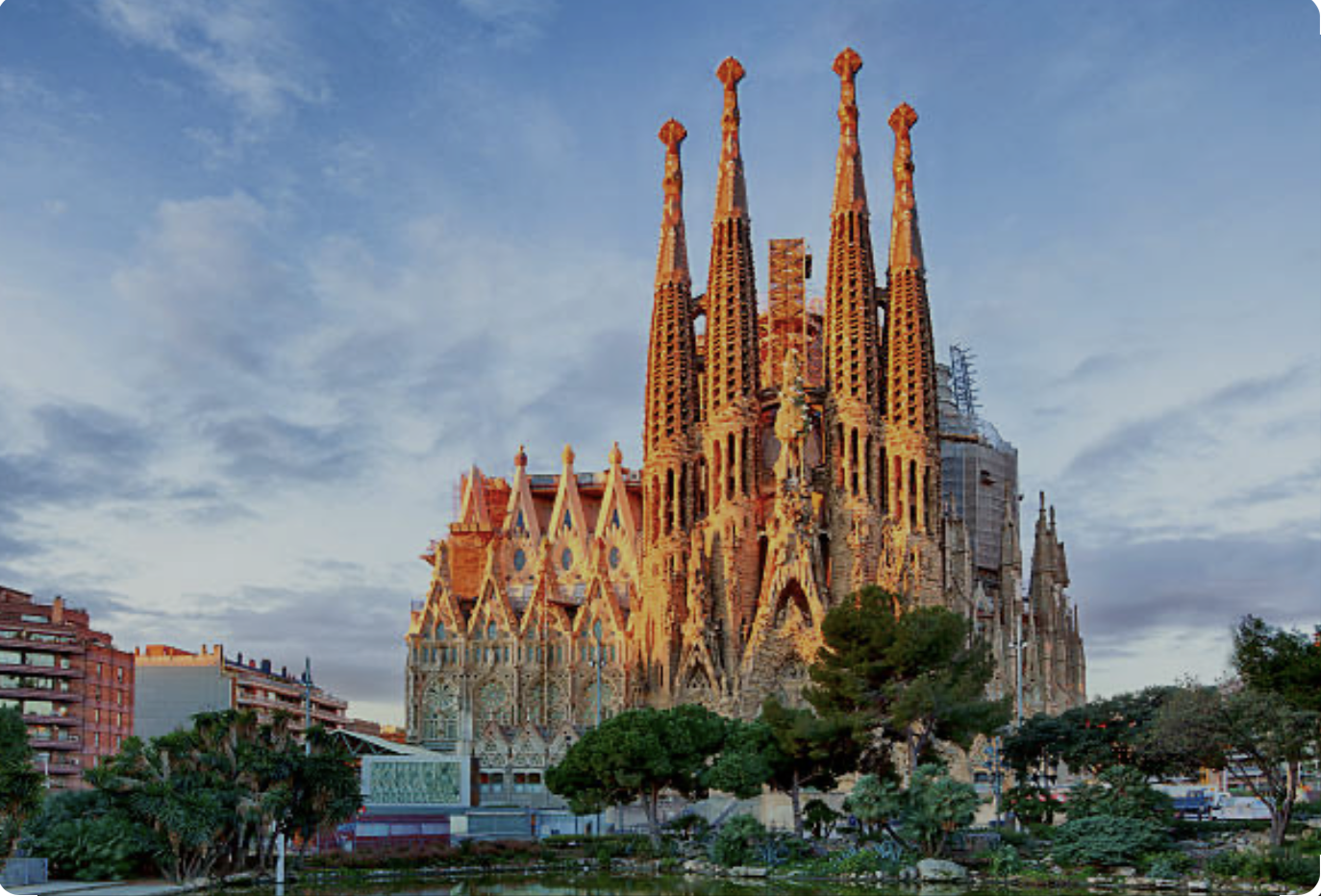 Exterior view of Sagrada Família cathedral showing the complete facade and spires against Barcelona skyline